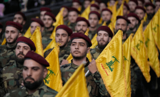 Photo of Hezbollah militants carrying flags of the movement south of Beirut, Lebanon